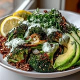 A wholesome Roasted Broccoli Bowl featuring golden, charred florets over grains, garnished with fresh parsley, sesame seeds, and avocado slices.