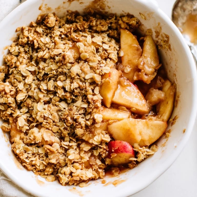 Homemade Apple Crumble dessert fresh from the oven, featuring a buttery, golden-brown crumble and juicy apple filling.