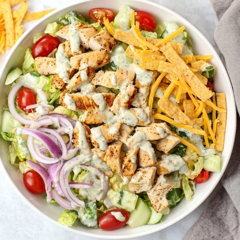 Overhead view of Jalapeño Ranch Chicken Salad with tender chicken, vibrant veggies, and ranch dressing drizzled on top.